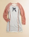 She'll be comfortable and fashionable in this pretty sweatshirt dress with a turn-back hem, reversed fabric sleeves and contrast trim. ScoopneckLong sleeves with reversed fabricPullover styleContrast solid trimFront graphicTurn-back hem80% cotton/20% polyesterMachine washImported