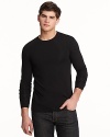 Long sleeve crewneck with wide cuff bands. Slimmer fitting with logo embroidered at bottom hem.