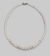 From the Akoya Collection. A graduated strand of white, round cultured Akoya pearls with diamond rondels set in 18k white gold. 7mm-9mm white round pearls Quality: A1 Diamonds, 0.08 tcw 18k white gold Length, about 18 Mikimoto signature clasp Imported