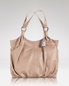 Crafted from Nappa leather, Cole Haan's tote is a luxe take on a classic shape. In a neutral shade, the carryall with works all with long--wear it with polished suits or your favorite jeans. Crafted from Nappa leather, Cole Haan's tote is a luxe take on a classic shape. In a neutral shade, the carryall with works all with long--wear it with polished suits or your favorite jeans.