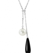 Black and white, and raved all over. This necklace, crafted from sterling silver, features both an onyx (8 mm x 25 mm) and a cultured freshwater pearl (10 mm), along with white topaz accents for a stunning look. Approximate length: 17 inches Approximate drop: 2 inches.