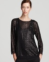 Sheer styling and a generous dose of sequins infuse this DKNY top with modern glamour. Team with metallic accents and light up the night.