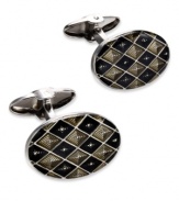 The perfect accent for the modern-day business man. These sleek oval-shaped cuff links feature rounded ends and a unique checkered design. Set in sterling silver with black and grey enamel overlay. Approximate length: 13/16 inch. Approximate width: 1/2 inch.