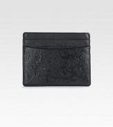 Store your business and credit cards in style with this compact case of smooth grain leather on one side and embossed paisley-printed leather on the other, finished with a signature cotton trim.Five card slotsCotton twill/leather liningLeather4W x 3HImported