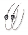 A jet hematite bezel-set crystal embellishment has an elegant, eye-catching effect on these trendy hoop earrings from Swarovski. Set in silver tone mixed metal. Approximate diameter: 1-7/8 inches.