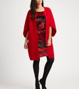 Sophisticated butterfly cocoon style in warm boiled merino wool.Open front Wide sleeves Seaming details About 35 from shoulder to hem Merino wool Dry clean Imported