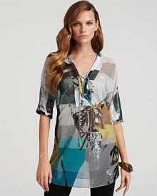 Mixed prints get dressed up with patches of sequins on Elie Tahari's Lori tunic, a silky style with graphic punch. Mixed prints get dressed up with patches of sequins on Elie Tahari's Lori tunic, a silky style with graphic punch.
