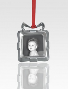 A charming way to hang a cherished photo on your tree, this sweet frame is designed to look like a tiny present with an abstract bow on top.Metal alloy and glassHandmadeSigned by designer Alvaro Uribe3.25H X 3WImported A charming way to hang a cherished photo on your tree, this sweet frame is designed to look like a tiny present with an abstract bow on top.Metal alloy and glassHandmadeSigned by designer Alvaro Uribe3.25H X 3WImported