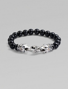 A strand of smooth black onyx beads, capped by dramatic carved raven's heads of sterling silver, clutching the clasp in their beaks. Black onyx Sterling silver Length, about 9¼ Lobster clasp Imported