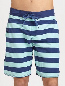 Stay stylish in the sun, the sand and beyond in these striped board shorts shaped in lightweight, breathable cotton.Drawstring tie waistSide welt pocketInseam, about 8NylonMachine washImported