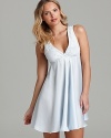 A flowy sleeveless chemise with lace detail along a surplice neckline.