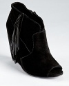 A peep toe bootie gets the fringe treatment on STEVEN BY STEVE MADDEN's soft suede Samaraa wedges.