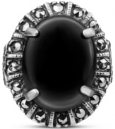 Punctuate your look. This bold, oval-shaped ring highlights a black onyx gemstone (4-3/4 ct. t.w.) surrounded by glittering marcasite (1/4 ct. t.w.) in sterling silver. Size 7.