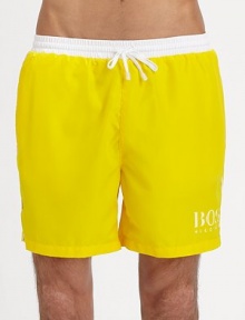 These solid swim trunks sport a drawstring waistband and the classic BOSS logo.Elastic drawstring waistSide slash pocketsPolyester liningPolyamideMachine washImported