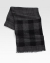A modern cool check design is printed on this rich wool blend scarf with allover fringe trim.Fringed ends28W x 72LViscose/wool/polyamide/modal/cottonDry cleanMade in Italy