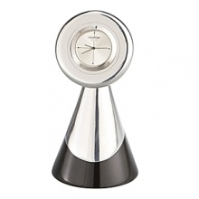 Lend a time-stopping touch to any desk, den, or bookshelf with this ruggedly elegant creation of Neil Cohen's. Part of the initial series of the Nambé Rocks Collection, the Clock is a first-time pairing of sleek granite with signature Nambé alloy that evokes the majestic natural beauty of the Southwest. Dramatically anchored by a base of gleaming metal and sleek black granite, the signature quartz-movement timepiece-with second hand and the Nambé name-is the ultimate display of prestigious simplicity. The tarnish-resistant alloy polishes to a silvery and timeless shine Lend a time-stopping touch to any desk, den, or bookshelf with this ruggedly elegant creation of Neil Cohen's. Part of the initial series of the Nambé Rocks Collection, the Clock is a first-time pairing of sleek granite with signature Nambé alloy that evokes the majestic natural beauty of the Southwest. Dramatically anchored by a base of gleaming metal and sleek black granite, the signature quartz-movement timepiece-with second hand and the Nambé name-is the ultimate display of prestigious simplicity. The tarnish-resistant alloy polishes to a silvery and timeless shine