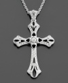 A traditional sterling silver cross pendant with ornate and delicate details featuring round-cut diamonds (1/5 ct. t.w.) for a pretty shimmer. Chain measures 18 inches; drop measures 2 inches.