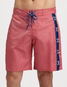 Bold, contrasting side stripes adorn these classic-fitting swim trunks, set in quick-drying nylon for superior fit and comfort.Drawstring waistRear flap pocketInseam, about 9NylonMachine washImported