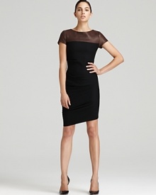 Sleek leather punctuates a Halston Heritage sheath dress, finished with an uneven hem for a contemporary approach to the classic silhouette. Team with monochrome accents for a clean modern look.