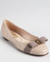 In micro-grid textured patent, Salvatore Ferragamo's classic Varina flat feels fresh for the season.