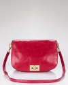 Let Tory Burch's pop-of-color messenger enliven your fall look. In a warm lipstick hue, this chicly-sized bag pairs with a heritage-inspired coat to work a coolly-hued take on preppy.