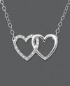 Tell her how she's captured your heart. This heart necklace features two interlocking hearts set in 14k white gold. One heart has been dusted in round-cut diamond accents. Approximate length: 16 inches. Approximate drop: 3/8 inch.