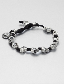 Knotted cord bracelet is interupted with impeccably sculpted skulls of sterling silver for a modern, masculine addition to your accessory collection.Sterling silverWaxed cottonDiameter, about 3Drawstring closureMade in USA Knotted cord bracelet is interupted with impeccably sculpted skulls of sterling silver for a modern, masculine addition to your accessory collection.Sterling silverWaxed cottonDiameter, about 3Drawstring closureMade in USA