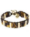 Neutral chic. Tortoise-shell acetate links combine with gold tone mixed metal details and a toggle clasp on Michael Kors trendy bracelet style. Approximate length: 7-1/2 inches. Approximate width: 1/2 inch.