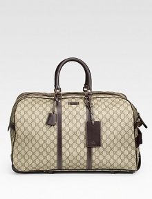 Signature GG plus duffel with leather trim and a retractable handle. Double-zip closure Top handles Light gold hardware Interior zip pocket 21W X 11H X 12D Made in Italy Signature GG plus duffel with leather trim and a retractable handle. Double-zip closure Top handles Light gold hardware Interior zip pocket 21W X 11H X 12D Made in Italy