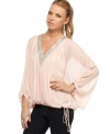 Glittery beads create a frosted trim on this gauzy, chiffon top from Baby Phat! Pair it with your favorite skinnies for a look that wears like a dream.