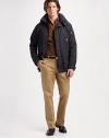 A trim-fitting jacket designed in water-resistant technical fabric and outfitted with a detachable hood and plenty of pockets for a contemporary touch. Zip front with snap storm flap Detachable hood Metal grommets under the arms Sleeve, chest zip pockets Waist flap pockets Fully lined About 28 from shoulder to hem Polyester Dry clean Imported 