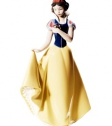 The fairest in the land, this Snow White figurine is nothing short of 12 dwarves. Stopping to smell the flowers, she's epitome of Disney princesses in handmade porcelain from Nao by Lladro.