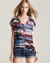 Channel tropical-getaway style in this billowy GUESS top, featuring a vibrant palm-tree print.