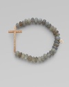 This grey moonstone beaded, stretch design is accented with a diamond embellished 14k rose gold cross on the horizontal for a modern look. Grey moonstone beads14K rose goldDiamonds, .26 tcwLength, about 6¾Elastic slip-on styleMade in USA of imported materials