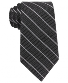 Skinny stripes make a subtle statement that still gets noticed with this DKNY silk tie.
