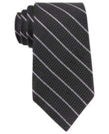 Skinny stripes make a subtle statement that still gets noticed with this DKNY silk tie. Skinny stripes make a subtle statement that still gets noticed with this DKNY silk tie.