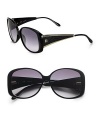 This stylish design features the structure of a square frame with the softness of a round frame. Available in black with smoke gradient lens. Logo templesGoldtone accents100% UV protectionMade in Italy 