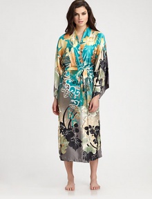 Luxurious silky-smooth fabric takes on a beautiful floral print in refreshing, tropical hues. V-neckDropped shouldersThree-quarter kimono sleevesSelf-tie waistAbout 49 from shoulder to hemPolyesterMachine washImported