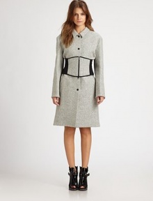 Lightweight, wool-rich coat shaped with a modified Peter Pan collar and partially exposed corset. Modified Peter Pan collarLong sleevesButton frontPartially exposed zippered corsetFully linedLonger length hits just above the knee65% virgin wool/25% nylon/10% alpacaDry cleanImportedModel shown is 5'8 (175cm) wearing US size 4.