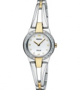 Add a new favorite to your jewelry box with this elegant and energy-efficient watch by Seiko. Polished two-tone stainless steel bangle bracelet and round case, 22mm. Bezel crystallized with Swarovski elements. White dial features gold tone dot markers, two hands and logo. Solar-powered quartz movement. Water resistant to 30 meters. Three-year limited warranty.