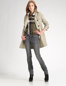 A classic essential with utility styling like shoulder epaulettes and a gunflap.Double-breasted style Buckled sleeves Buckled self belt Buttoned side pockets Back flap About 34½ from shoulder to hem Cotton; dry clean Imported A classic essential with utility styling like shoulder epaulettes and a gunflap.Double-breasted style Buckled sleeves Buckled self belt Buttoned side pockets Back flap About 34½ from shoulder to hem Cotton; dry clean Imported