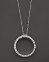 From the Tiny Treasures collection, a small diamond circle necklace; with signature ruby accent. Designed by Roberto Coin.