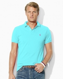 Cut in a trim, modern silhouette, a short-sleeved polo shirt is rendered in breathable cotton mesh with signature embroidery for iconic style. Cut in a trim, modern silhouette, a short-sleeved polo shirt is rendered in breathable cotton mesh with signature embroidery for iconic style.