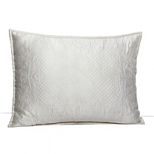 This luxurious all-white bedding ensemble incorporates couture-inspired details - from intricate floral embroidery to elegant silk matelasse - for a feminine vision of modern romance. This luxurious all-white bedding ensemble incorporates couture-inspired details - from intricate floral embroidery to elegant silk matelasse - for a feminine vision of modern romance.