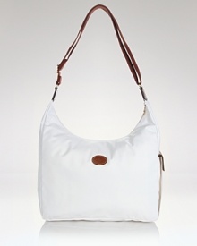 Longchamp's nylon hobo is a fuss-free take on a classic shape. Carry the pretty-practical style to add an enviable dose of Parisian chic to everyday looks. Longchamp's nylon hobo is a fuss-free take on a classic shape. Carry the pretty-practical style to add an enviable dose of Parisian chic to everyday looks.