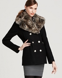 Wrapped in a sumptuous faux-fur collar, a double-breasted Laundry by Shelli Segal wool coat flaunts silver tone buttons and edgy exposed zip pockets for standout chic as snowflakes fall.