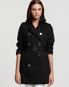 Always be timelessly chic in a classic Burberry Brit trench. This sleek belted jacket exudes class and sophistication day or night. An internal quilted vest lends added comfort.