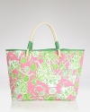 Start planning your tropical getaway with this Lilly Pulitzer tote, flaunting signature pink and green for a whimsical addition to your beach-chic style.