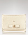 With a sleek attached bow, this classic Salvatore Ferragamo Saffiano card case makes a chic statement of luxury.