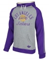 Keep warm as you cheer and rant for the LA Lakers in this pullover hoodie by adidas.